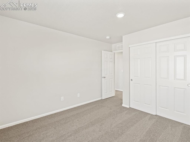 unfurnished bedroom featuring a closet and carpet floors