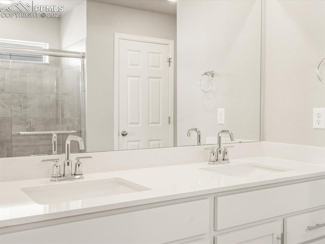 bathroom featuring an enclosed shower and vanity