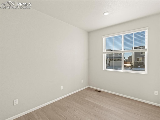 spare room featuring light hardwood / wood-style floors