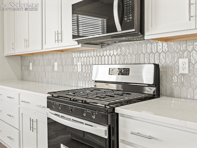 kitchen featuring light stone countertops, decorative backsplash, stainless steel gas stove, and white cabinetry