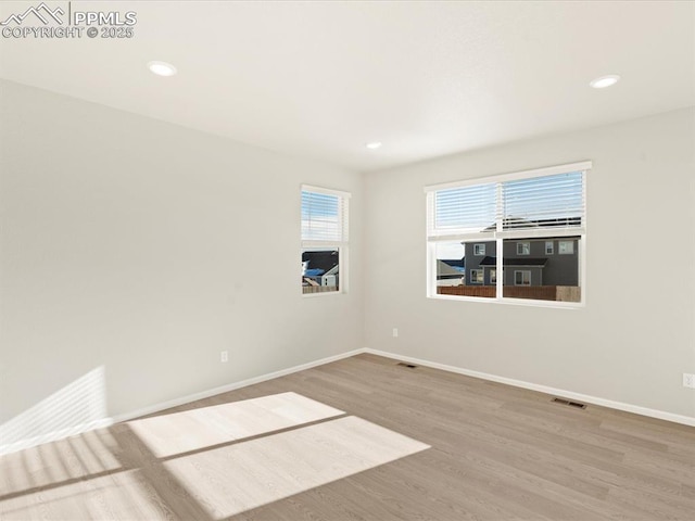 spare room with wood-type flooring