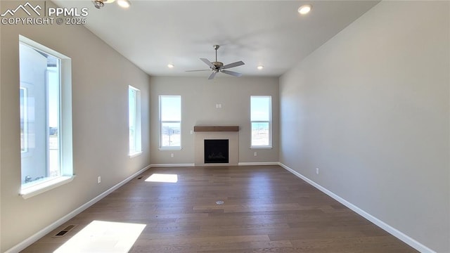 unfurnished living room featuring dark hardwood / wood-style floors and ceiling fan