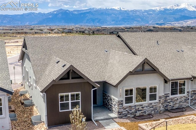 rear view of house featuring a mountain view