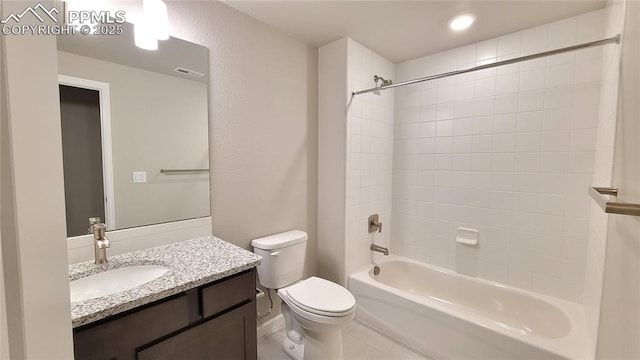 full bathroom with vanity, toilet, and tiled shower / bath