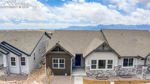 rear view of house with a mountain view and a patio