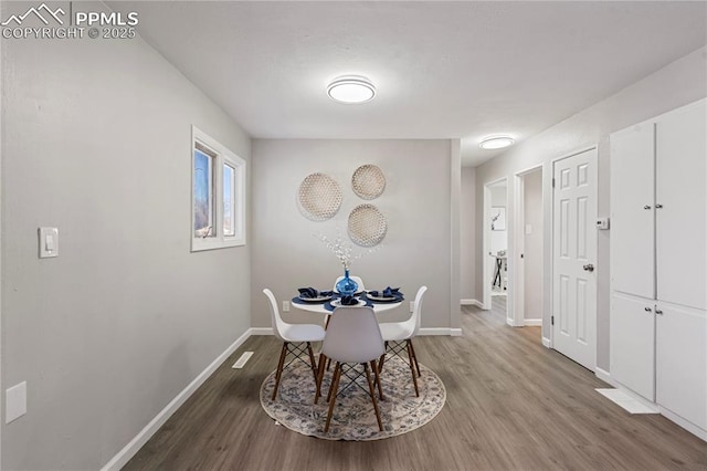 dining space with hardwood / wood-style floors