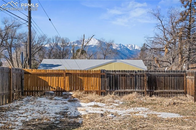 yard covered in snow with a mountain view