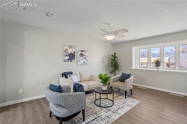 living room with ceiling fan and hardwood / wood-style flooring