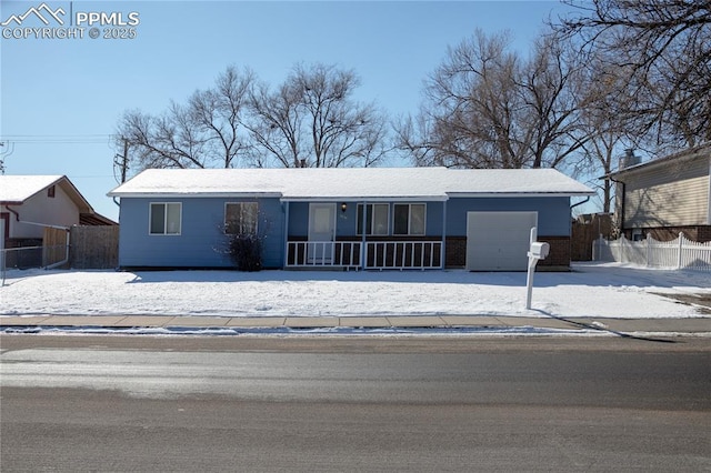 ranch-style house with covered porch and a garage