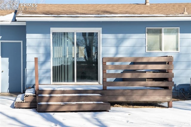 view of snow covered property entrance