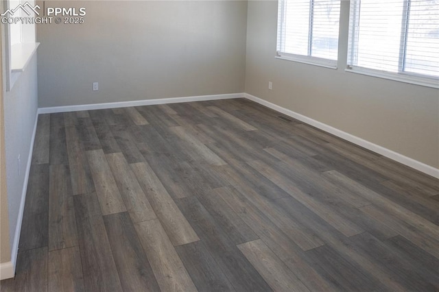 unfurnished room featuring dark wood-type flooring