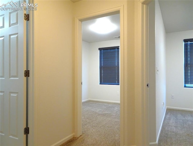 corridor featuring light colored carpet