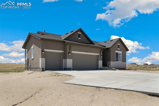 ranch-style house featuring driveway, an attached garage, and stucco siding