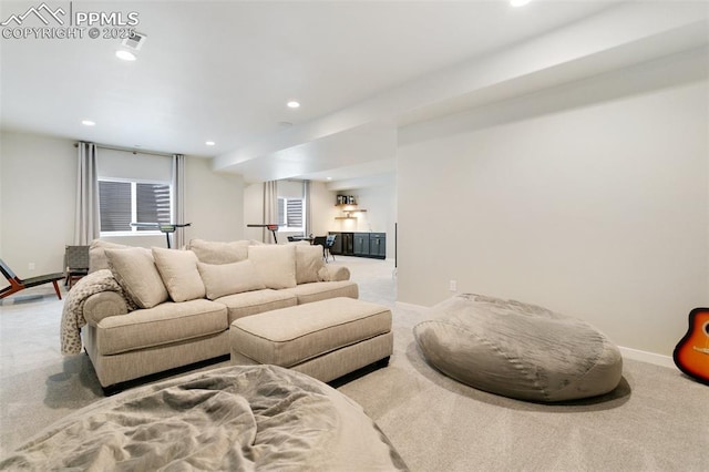 carpeted living area featuring recessed lighting and baseboards