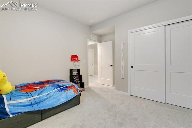 bedroom featuring light colored carpet and a closet