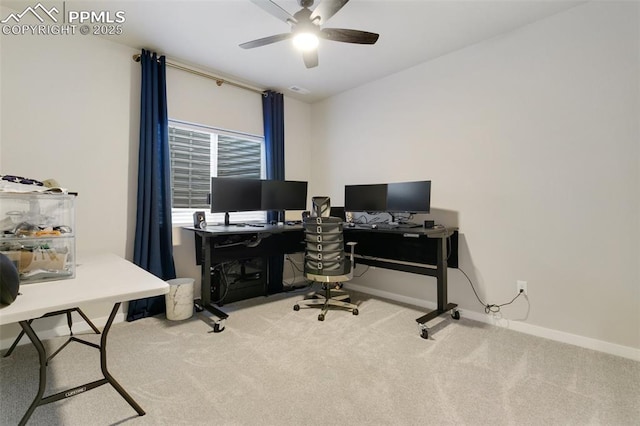 carpeted office with a ceiling fan and baseboards