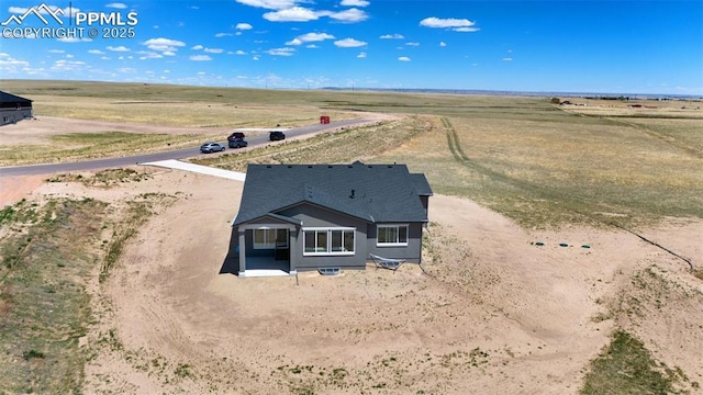 birds eye view of property with a rural view