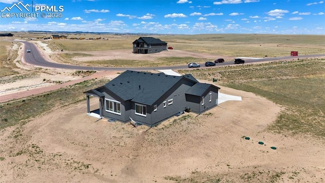 birds eye view of property with a rural view