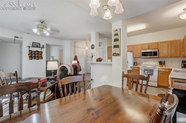 dining room with ceiling fan and sink