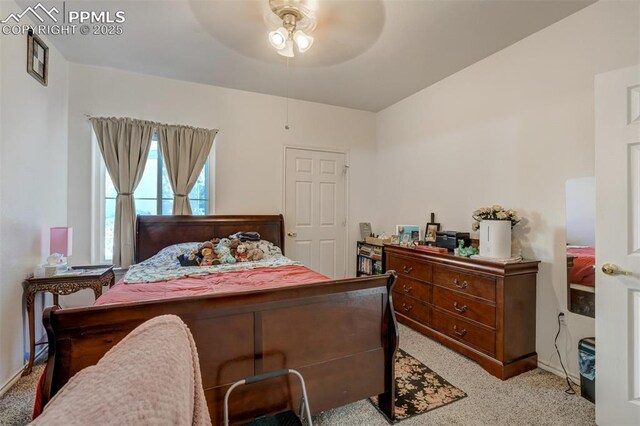 bedroom featuring ceiling fan and light carpet