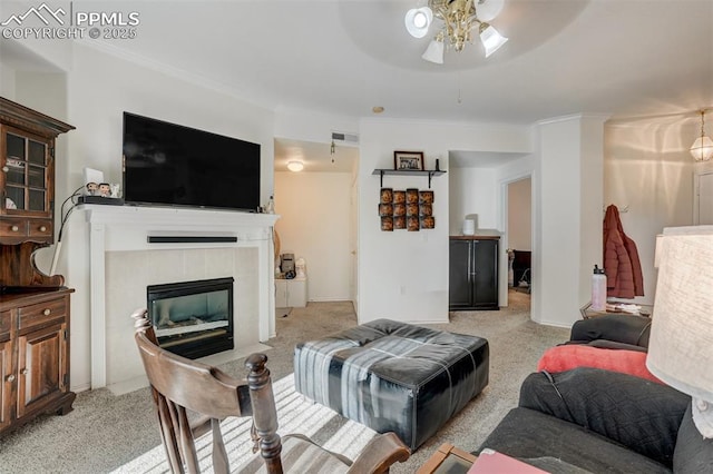 carpeted living room featuring a tiled fireplace and ceiling fan