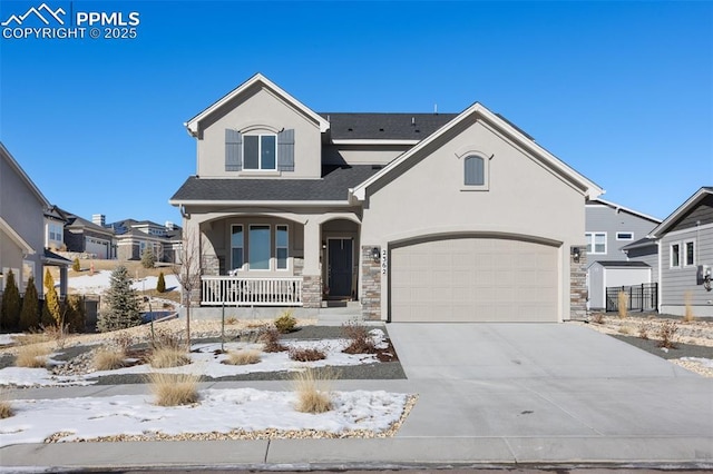 view of front facade featuring stucco siding, a porch, a residential view, stone siding, and driveway