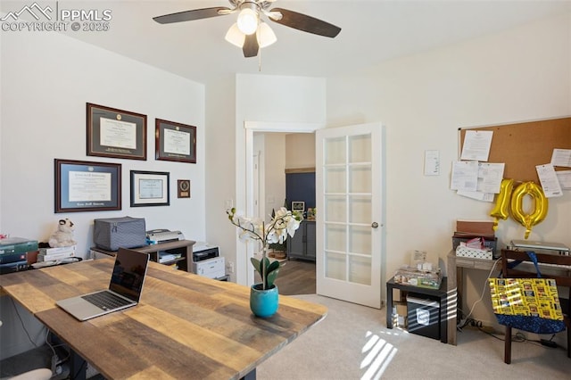 carpeted office space with ceiling fan and french doors