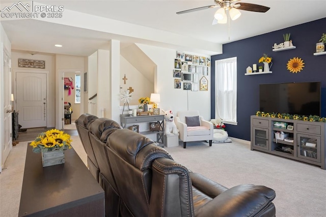 carpeted living room with ceiling fan