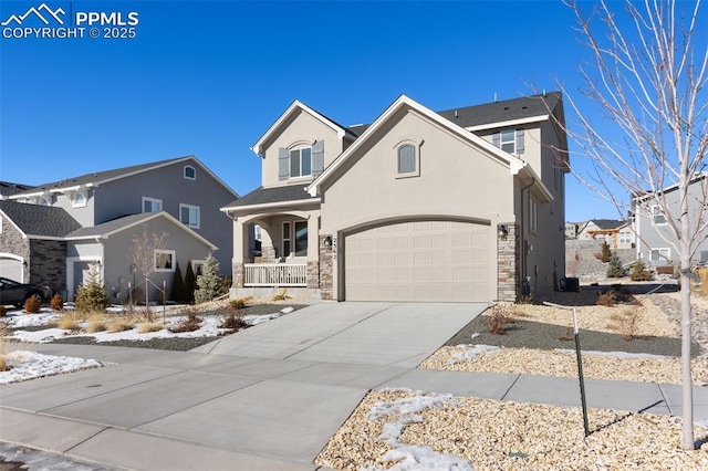 traditional-style home with stucco siding, a porch, a residential view, stone siding, and driveway