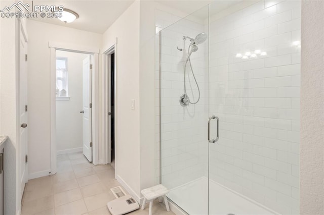 bathroom with tile patterned flooring, a shower with shower door, and vanity