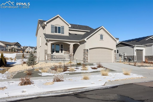 view of front of property featuring stucco siding, a porch, concrete driveway, a garage, and stone siding