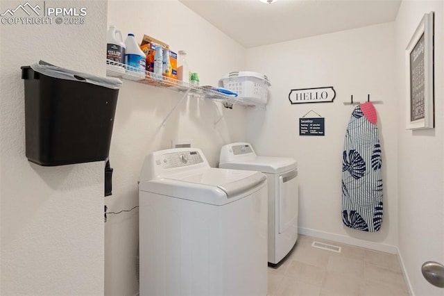 washroom with washing machine and clothes dryer