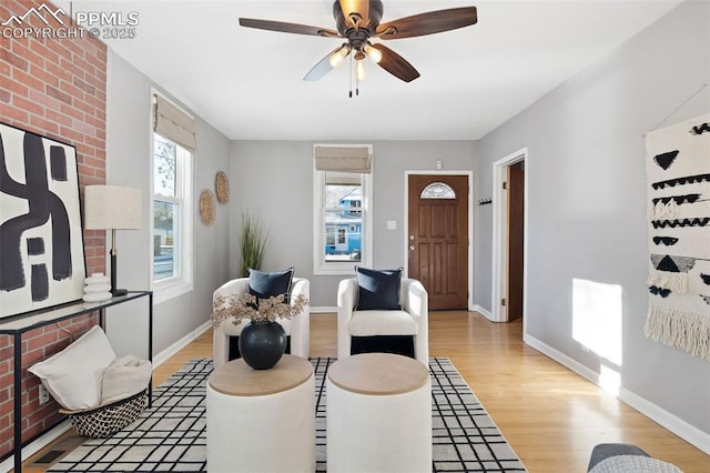 living room with ceiling fan, light hardwood / wood-style flooring, and plenty of natural light