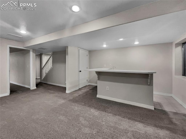 basement featuring dark colored carpet