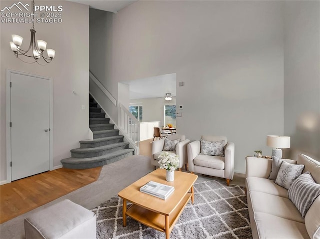 living room with hardwood / wood-style floors and an inviting chandelier