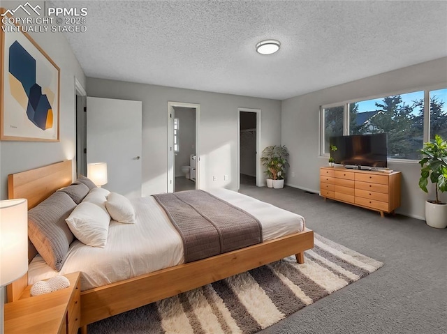 carpeted bedroom featuring a textured ceiling