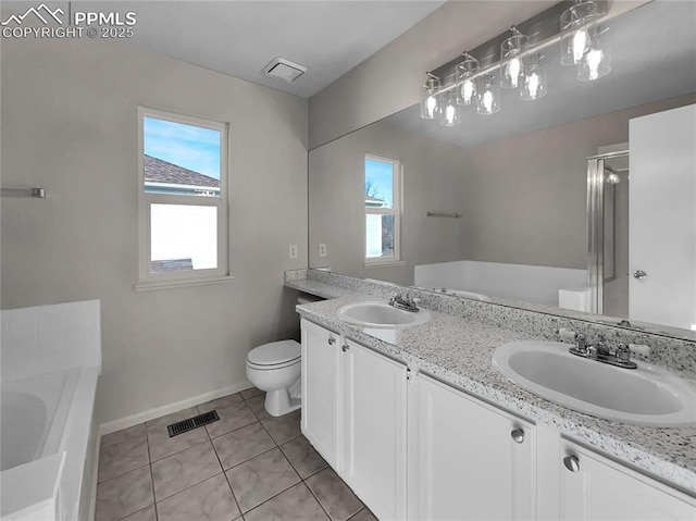 bathroom featuring tile patterned flooring, vanity, toilet, and a bathing tub