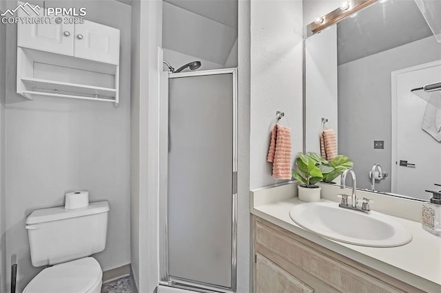 bathroom featuring toilet, vanity, and walk in shower