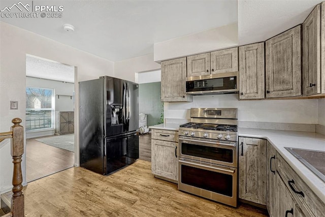 kitchen featuring appliances with stainless steel finishes and light wood-type flooring