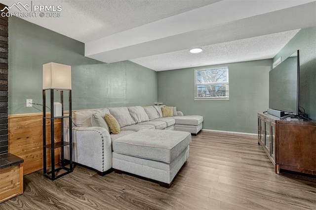 living room featuring dark hardwood / wood-style flooring and a textured ceiling