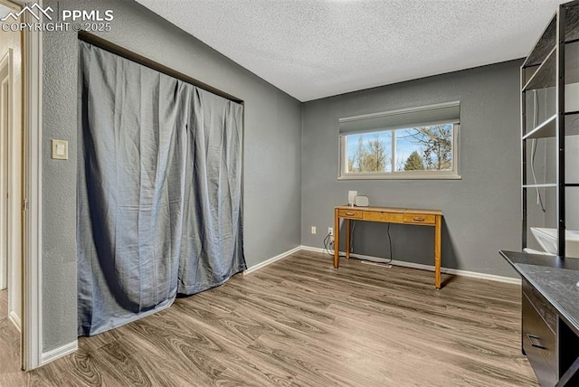 interior space with hardwood / wood-style flooring and a textured ceiling