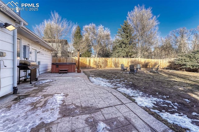 view of patio / terrace with a grill and a hot tub