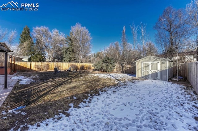 yard covered in snow with a shed