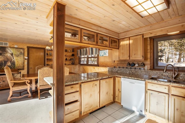 kitchen featuring sink, dishwasher, light tile patterned floors, dark stone counters, and wood ceiling