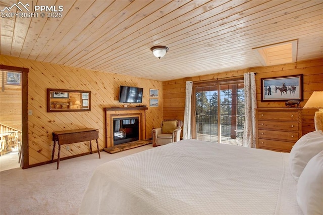 carpeted bedroom with wooden ceiling, access to exterior, and a skylight