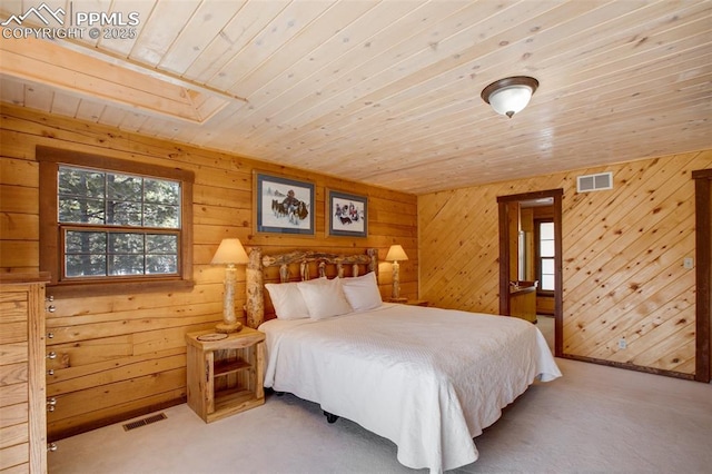 bedroom with wooden walls, wooden ceiling, and carpet flooring