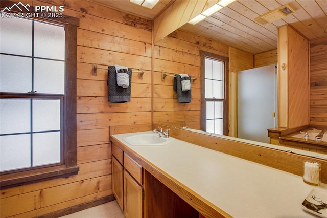 bathroom featuring wooden walls, wood ceiling, and vanity