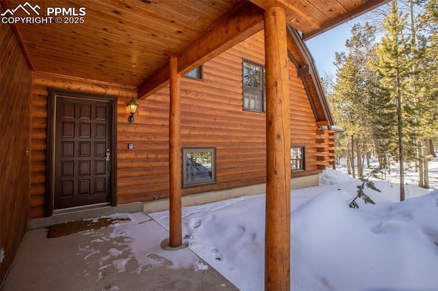 view of snow covered property entrance