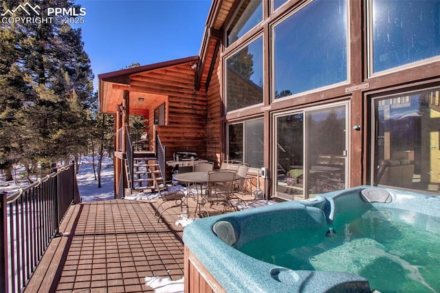 wooden terrace with a hot tub