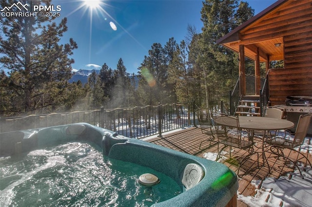 exterior space featuring a hot tub and a grill